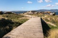 Landscape with a wooden walk way crossing a wild beach Royalty Free Stock Photo