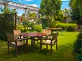 dining table set in lush garden Royalty Free Stock Photo