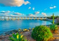 Coronado Bay Bridge in San Diego with boats and succulents on shoreline at dusk. Royalty Free Stock Photo