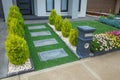 A landscaped small front yard with a paver walkway to the front porch and synthetic turf. Royalty Free Stock Photo
