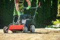 Landscaper Pushing Lawn Aerator