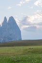 Landscapes on Alpe di Siusi with Schlern Mountain Group in Background and small cabins on the grassland in Summer during the sunse