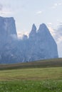 Landscapes on Alpe di Siusi with Schlern Mountain Group in Background and small cabins on the grassland in Summer during the sunse