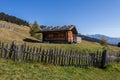 Landscapes on Alpe di Siusi with small cabins on grassland in autumn, South Tyrol, Italy