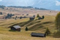 Landscapes on Alpe di Siusi with small cabins on grassland in autumn, South Tyrol, Italy