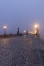 Landscapes on Charles Bridge with Bridge Tower and Statues at sunrise in a foggy morning, Prague, Czech Republic, Europe Royalty Free Stock Photo