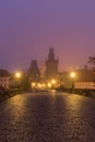 Landscapes on Charles Bridge with Bridge Tower and Statues at sunrise in a foggy morning, Prague, Czech Republic, Europe Royalty Free Stock Photo