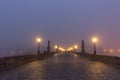 Landscapes on Charles Bridge with Bridge Tower and Statues at sunrise in a foggy morning, Prague, Czech Republic, Europe Royalty Free Stock Photo