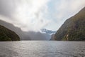 Landscapes of FjordLand. Snowy peaks in the clouds. New Zealand