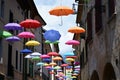 The small streets of the city center of Belluno covered by colorful umbrellas