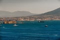 Landscapes of Naples; the coast of the city with houses on the mountain and with boats in the sea Royalty Free Stock Photo