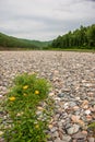 Landscapes of Siberia. Early morning on the Kiya River. Mountains, forest coast strewn with stones. Royalty Free Stock Photo