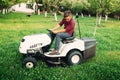 Landscaping details - mowing lawn with professional tools in garden