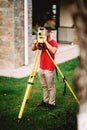 landscaping - surveyor engineer in garden elevation working with total station theodolite Royalty Free Stock Photo