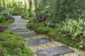 Landscaping in the green garden. pathway in park,curve walkway with stone tile Royalty Free Stock Photo