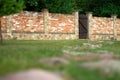 Landscaping. Red brick fence with brown wooden gate in the courtyard of private house. Stone path. Royalty Free Stock Photo