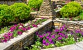 Landscaping with retaining walls and flowerbeds in residential house backyard