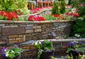 Landscaping with retaining walls and flowerbeds in residential house backyard