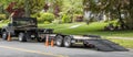 Landscaping truck with empty flatbed trailer