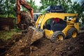 Landscaping works with bulldozer and excavator at home construction site Royalty Free Stock Photo