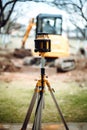 Landscaping works with excavator. Surveyor equipment optical level or theodolite at construction site Royalty Free Stock Photo