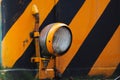 Landschaftspark Duisburg, Germany: Close up of electric lamp of an old locomotive with yellow and black stripes