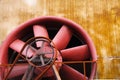 Landschaftspark Duisburg, Germany: Close up of red turbine with driving belt and rusty steel wall