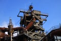 Landschaftspark Duisburg, Germany: Low angle view on stairways into deep blue sky at corroded tower with rusty pipeline Royalty Free Stock Photo