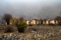 Landskape view on old stone abandoned mountain village in fog Royalty Free Stock Photo