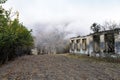 Landskape view on old stone abandoned mountain village in fog Royalty Free Stock Photo