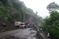 landslide blocking a road, with police and rescue vehicles parked nearby Royalty Free Stock Photo