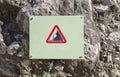 Landslide Caution falling rocks sign attached to the rock Royalty Free Stock Photo