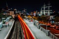 Landungsbruecken in Hamburg at night. Amazing light trails from the train movement. Urban cityscape of Harbor and metro Royalty Free Stock Photo