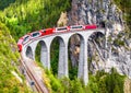 Landwasser Viaduct in Filisur, Switzerland. It is landmark of Swiss Alps. Bernina Express train on railroad bridge in mountains. Royalty Free Stock Photo