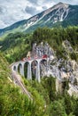 Landwasser Viaduct in summer, Filisur, Switzerland. Alpine landscape with Rhaetian express running on mountain railway