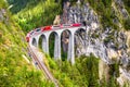 Landwasser Viaduct in summer, Filisur, Switzerland. It is landmark of Swiss Alps. Nice Alpine landscape. Red train of Bernina Royalty Free Stock Photo