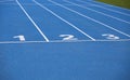 lanes of a blue athletic track with one two and three numbers Royalty Free Stock Photo