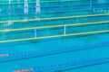 Lanes in a competition olympic size outdoor swimming pool. Calm Water background. Royalty Free Stock Photo
