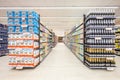 Lanes of shelves with aisle of goods products inside a supermarket