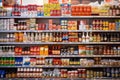 Lanes of shelves with goods products inside a supermarket. Variety of preserves and pasta.