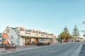 LANGEBAAN, SOUTH AFRICA, AUGUST 20, 2018: A sunset street scene, with the Marra Square Centre, people and vehicles, in Langebaan