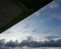 the evening sky with the expanse of clouds partially covered by the roof