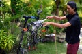 Asian man are washing road bicycle near by home