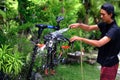 Asian man are washing road bicycle near by home