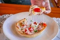 Hungarian pancakes langos with ham and cheese close-up on the table