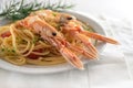Langoustine, also called scampi or Norway Lobster, on a Mediterranean spaghetti meal with tomatoes, garlic, parmesan cheese and
