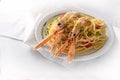 Langoustine, also called scampi or Norway Lobster, on a Mediterranean spaghetti meal with tomatoes, garlic, parmesan cheese and