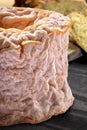 A Langres cheese on a black cheese board Royalty Free Stock Photo