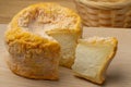 Langres cheese refined with champagne and a piece on a cutting board
