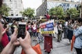 A language education institution staff wears a champion costume and recommends foreign language courses to parents of students out